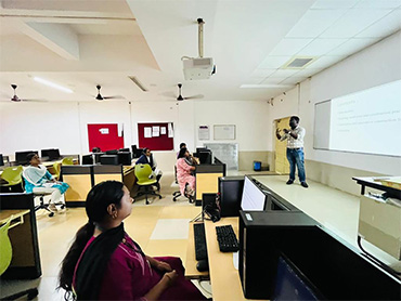 Two men in bicycle jerseys sitting outside at table having coffee